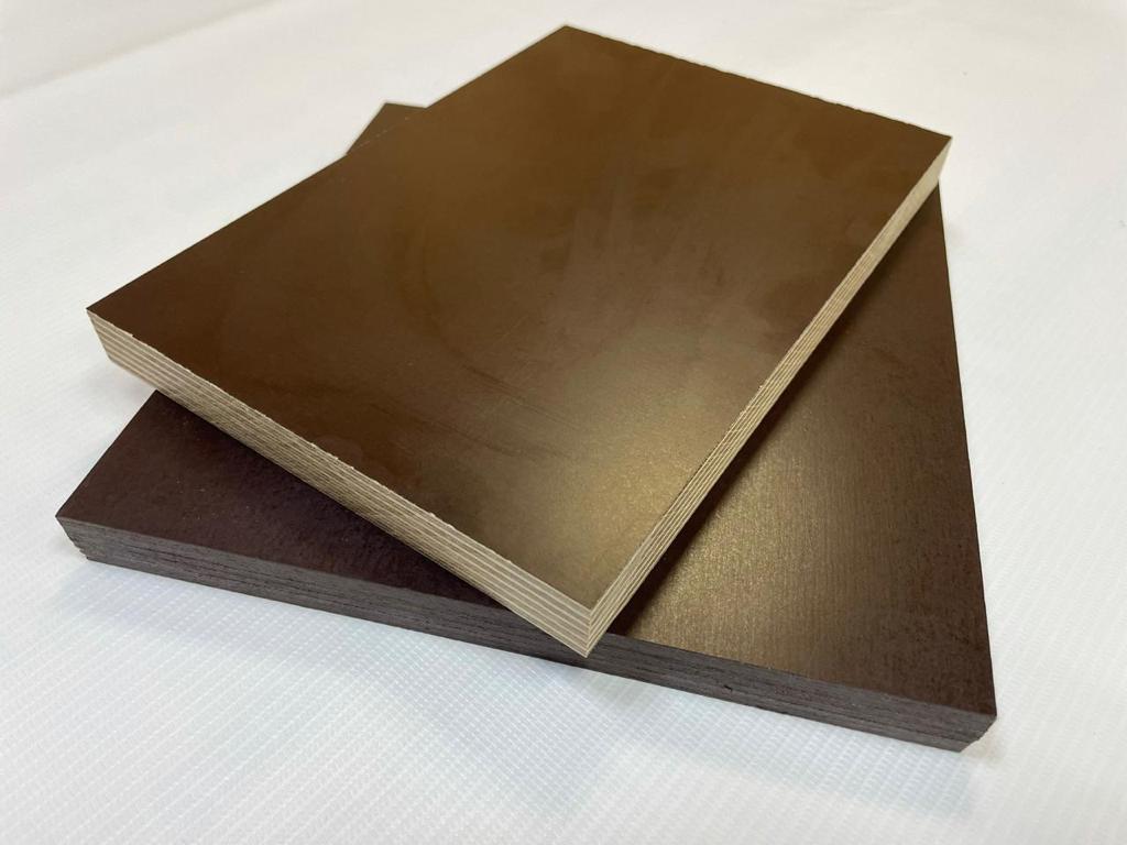 Birch film faced plywood panels with dark brown phenolic surface showing cross-laminated birch veneer layers