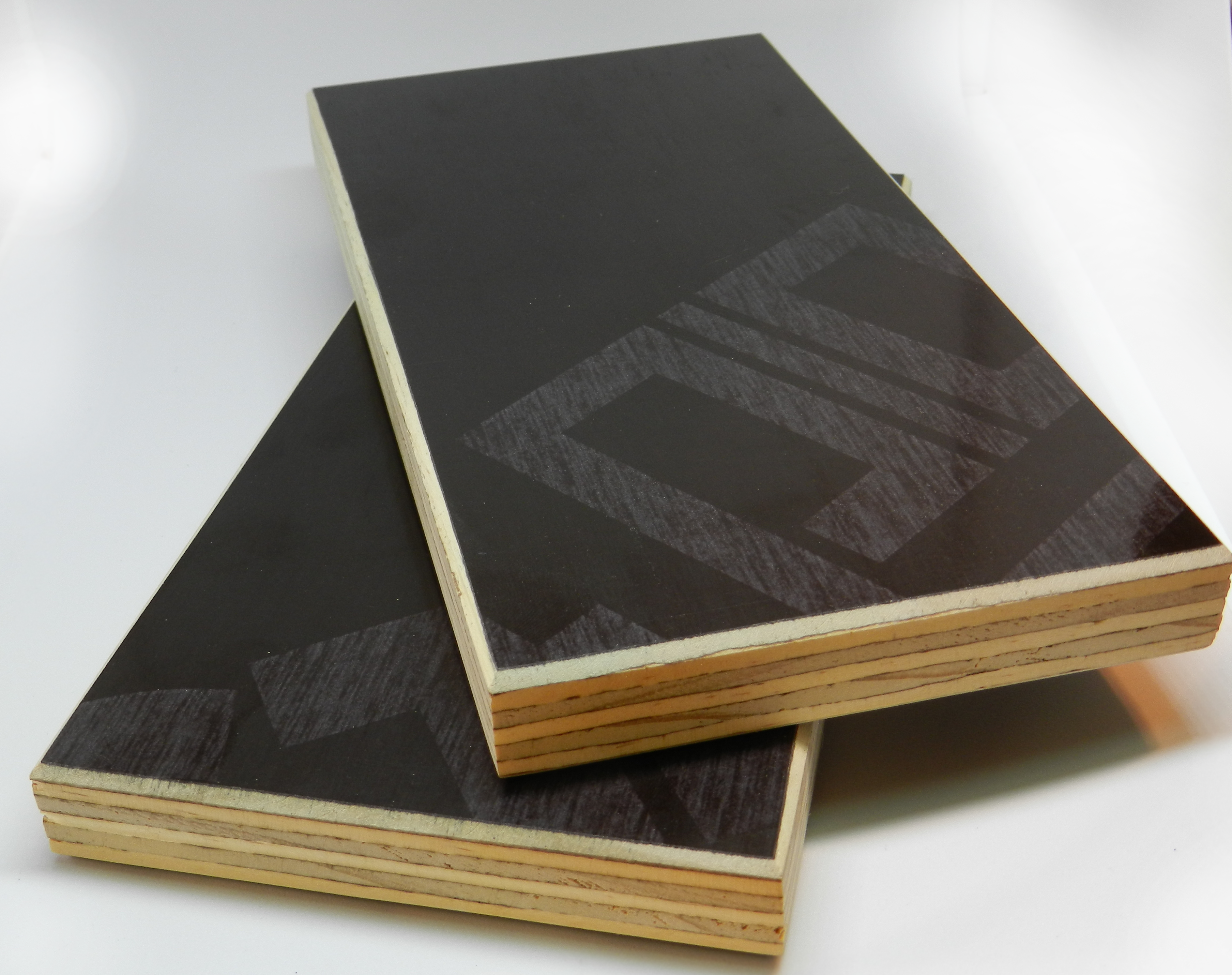 Pine Film Faced Plywood panel detail showing core and dark brown phenolic surface